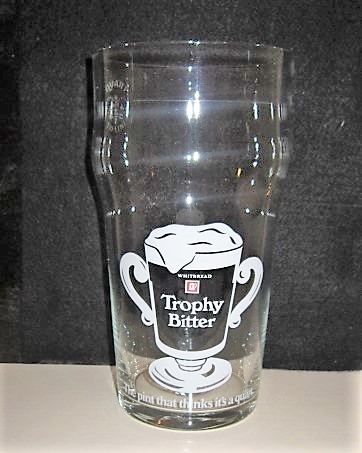 beer glass from the Whitbread  brewery in England with the inscription 'Whitbread Trophy Bitter The Pint That Thinks It's A Quart'