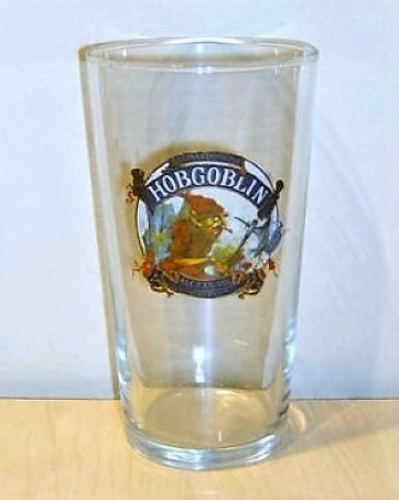 beer glass from the Wychwood  brewery in England with the inscription 'Extra Strong Ale Hobgoblin ALC 5% VOL Wynchwood Brewery '