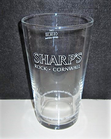 beer glass from the Sharp's brewery in England with the inscription 'Sharp's Rock Cornwall Narural Ingredients Cornish Water, English Malted Barley, Whole Hop Flowers And Sharp's unique Yeast'