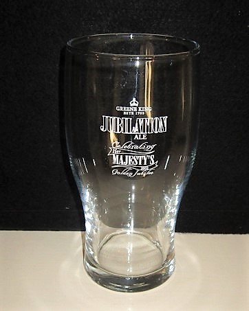 beer glass from the Greene King brewery in England with the inscription 'Green King Jubilation Ale Celebrating Her Majestys 2002 Golden Jubilee'