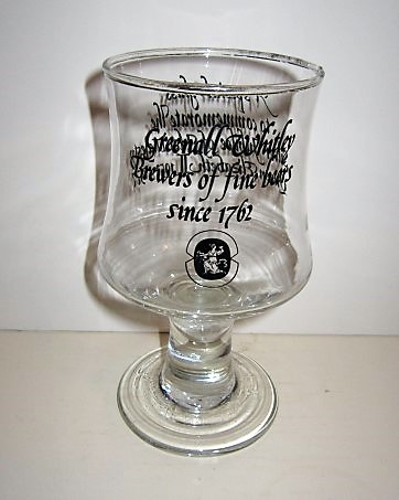 beer glass from the Greenall Whitley  brewery in England with the inscription 'Greenall Whitley Brewers Of Fine Beers Since 1762'