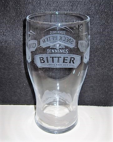 beer glass from the Jennings brewery in England with the inscription 'Jennings Cumberland Ale Jennings Bitter Lakeland Ale Jennings Cocker Hoop Golden Ale Jennings Sneck Lifter Strong Ale'