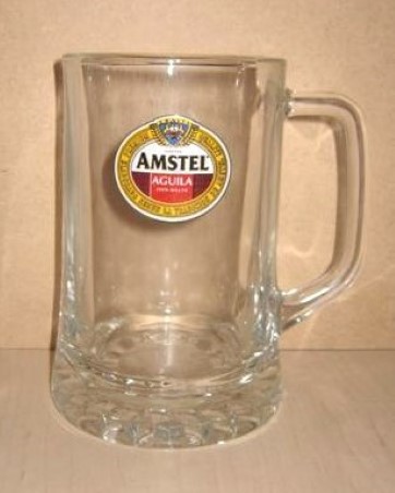 beer glass from the Aguila  brewery in Spain with the inscription 'Amstel Aguila 100% Malta Premium Quality Elaborada Segun La Tradicion De Amstel'