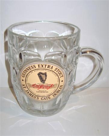 beer glass from the Guinness  brewery in Ireland with the inscription 'Guinness Extra Stout. St James's Gate Dublin. Bottled By Guinness'