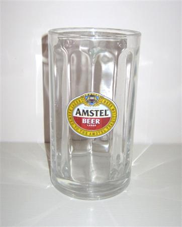 beer glass from the Amstel brewery in Netherlands with the inscription 'Amstel Beer Lager. Larger Beer Brewrd To The Amstel Tradition '