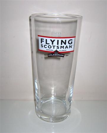 beer glass from the Caledonian  brewery in Scotland with the inscription 'Flying Scotsman. Edingburgh To London Caledonian Est 1869'