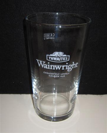beer glass from the Thwaites brewery in England with the inscription 'Thwaites Wanwright Exquisitely Lovely Golden AleA Breath Of Fresh Ale'
