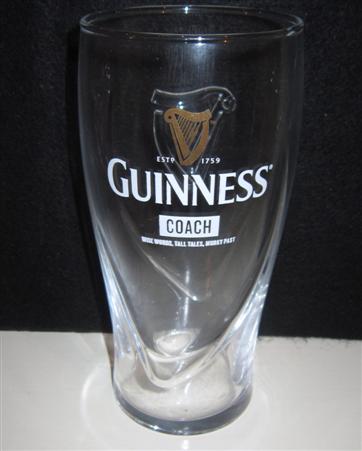 beer glass from the Guinness  brewery in Ireland with the inscription 'Guinness Estd 1759, Coach, Wise Words, Tal Tails, Murky Past'