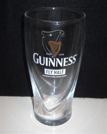 beer glass from the Guinness  brewery in Ireland with the inscription 'Guinness Estd 1759, Fly Half, Physically Timid, Boldly Verbal,'