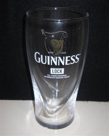 beer glass from the Guinness  brewery in Ireland with the inscription 'Guinness Estd 1759, Lock, Tall, Strong Powerhouse, Untroubled By Conscious Thougt'