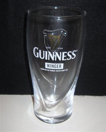 beer glass from the Guinness  brewery in Ireland with the inscription 'Guinness Estd 1759, Winger, Found On The Fringes, Hates A Dirty Kit'
