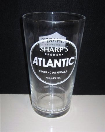 beer glass from the Sharp's brewery in England with the inscription 'Sharp's Brewery Atlantic, Rock Cornwall ALC 4.2% Vol. Cornish Water. English Malted Barley. Whole Hop Flowers. Sharps Unique Yeast'
