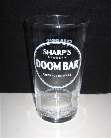 beer glass from the Sharp's brewery in England with the inscription 'Sharp's Brewery, Doombar Rock Cornwall. Only Four Natural Ingredients, English Malt Barley, Whole Hop Flowers, Sharp's Unique Yeast, Cornish Water'