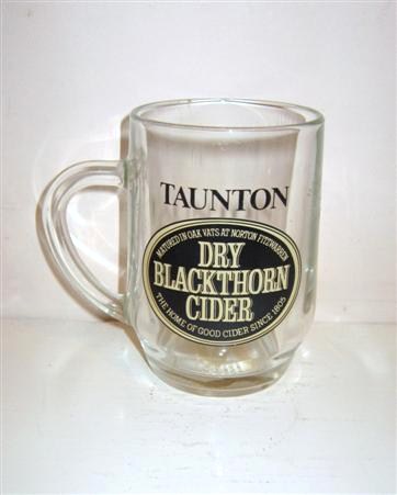 beer glass from the Matthew Clark  brewery in England with the inscription 'Taunton Dry Blackthorne Cider, Matured In Oak Vats At Norton Fitzwarren. The Home Of Good Cider Since 1805'