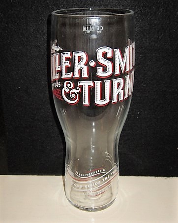 beer glass from the Fuller's brewery in England with the inscription 'Fuller. Smith & Turner Estd 1845, Proud Purveyors Of New Wave Lagers. Brewed Beside The Thames'