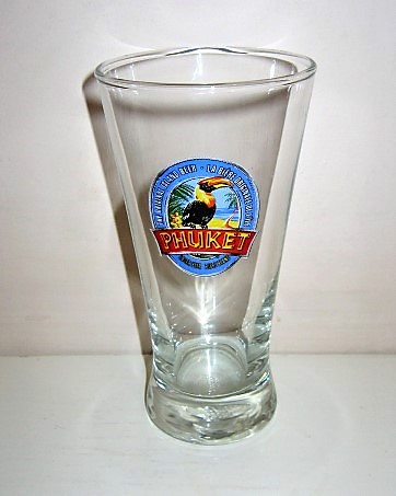 beer glass from the San Miguel  brewery in Thailand with the inscription 'Phuket The Original Island Beer, La Biere Original De L'ile Lager Beer Biere Blabc'