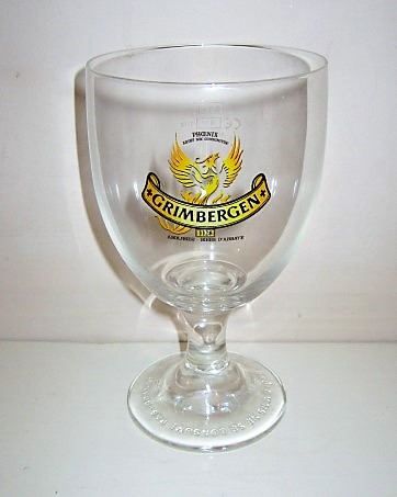 beer glass from the Grimbergen brewery in Belgium with the inscription 'Grimbergen 1128 Phoenix Arubt Nbc Consumitur Abdijbier Biere D'abbaye'