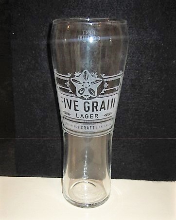 beer glass from the Shepherd Neame brewery in England with the inscription 'Five Grain Lager Refreshing Craft Balanced'