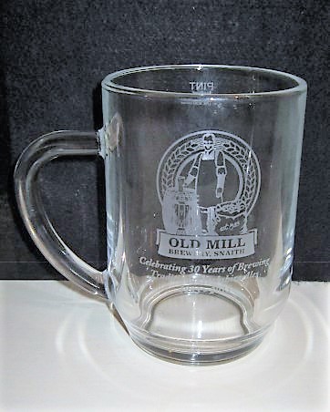 beer glass from the Old Mill  brewery in England with the inscription 'Old Mill Brewery, Celebrating 30 Years Of Brewing Traditional Yorkshire Ales'