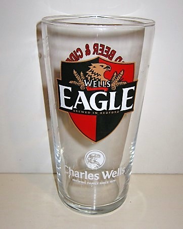 beer glass from the Charles Wells brewery in England with the inscription 'Wells Eagle Brewed In Bradford Charles Wells Brewing Family Since 1876'