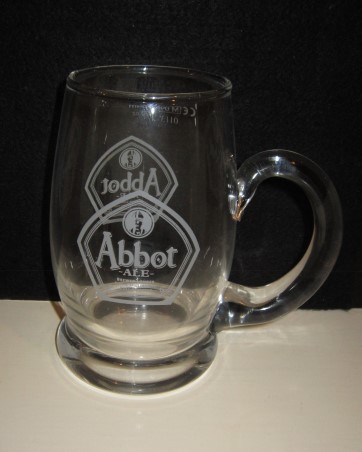 beer glass from the Greene King brewery in England with the inscription 'Abbot Ale Brewed Longer For A Distinctive Full Flavour'