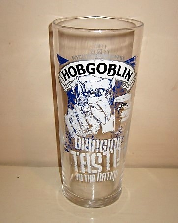 beer glass from the Wychwood  brewery in England with the inscription 'Wychwood Brewery Hobgoblin Bringing Taste To The Nation'