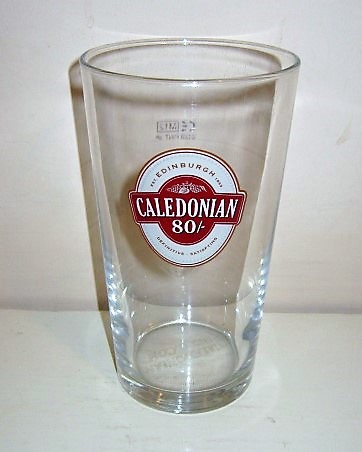 beer glass from the Caledonian  brewery in Scotland with the inscription 'Caledonian 80/- EST Edinburgh 1869 Definitive Satisfying'