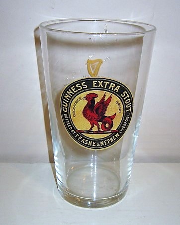 beer glass from the Guinness  brewery in Ireland with the inscription 'Guinness Extra Stout Bottled By T.F.Ashe  Nephew Liverpool Cockatrice Brand'