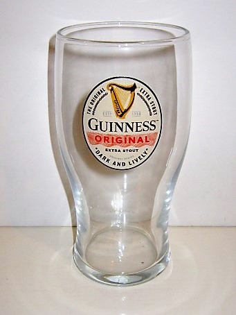 beer glass from the Guinness  brewery in Ireland with the inscription 'Guinness Original, The Original Extra Stout Dark And Lively'