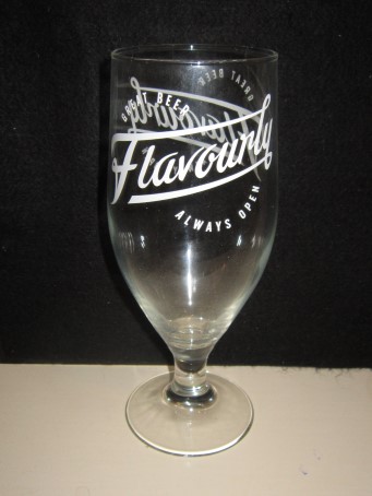 beer glass from the Bad Co brewery in England with the inscription 'Flavourly Great Beer Always Open'