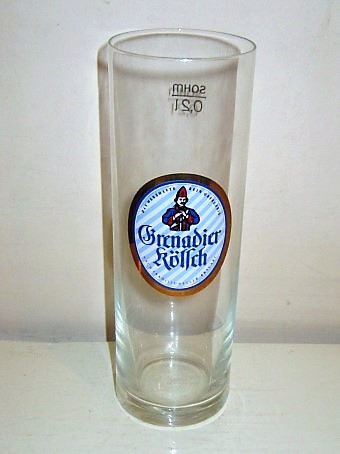 beer glass from the Haus Klscher brewery in Germany with the inscription 'Grenadier Kolsch, Daz Herzhafte Rein Obergarig Nach Traditioneller Brauart'
