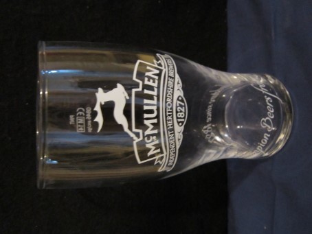 beer glass from the McMullen & Son Ltd brewery in England with the inscription 'McMullen Independent Hertfordshire Brewers 1827 Champion Beers From Hertfordshire Since 1827'