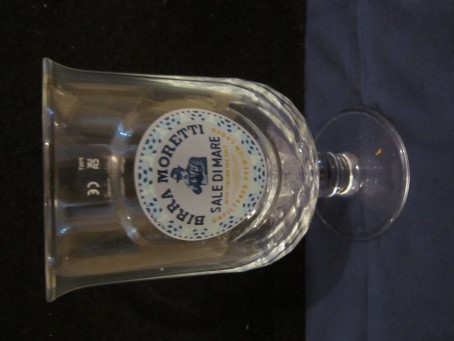 beer glass from the Moretti brewery in Italy with the inscription 'Birra Moretti Sale Di Mare, With Italian Sea Salt Unfiltered Premium Lager'