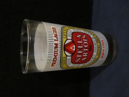 beer glass from the Stella Artois brewery in Belgium with the inscription 'Stella Artois 1366 Premium Lager Serve Cool, Brewed Under Licence From SA Brasseries Artois Brouwerijn NV'