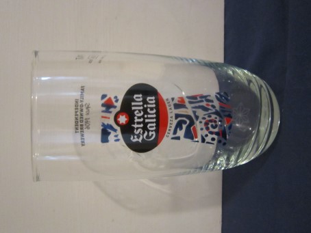 beer glass from the Estrella Glaicia brewery in Spain with the inscription 'Estrella Glaicia Lager Independent Family Owned Brewery Since 1906'