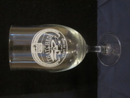 beer glass from the Windsor & Eton brewery in England with the inscription 'Windsor & Eaton The Thached Craft Pilsner ALC 4.8% Vol'