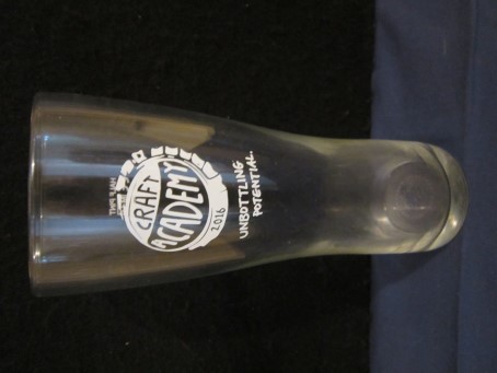 beer glass from the Greene King brewery in England with the inscription 'Craft Academy, Unbottling Potential'