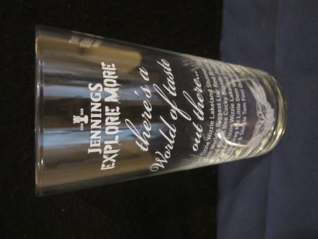 beer glass from the Jennings brewery in England with the inscription 'Jennings Explore More There's A World Of Taste Out There'