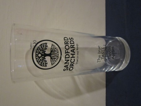 beer glass from the Sandford Orchards brewery in England with the inscription 'Sandford Orchards, True To Our Roots. The The True Taste Of Fresh Devon Apples'