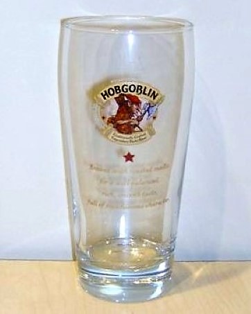beer glass from the Wychwood  brewery in England with the inscription 'Hobgoblin Traditionally Crafted Legendary Beer Brewed With Roasted Malts For A Well-balanced Rich Smooth Taste Full Of Mischievous Character'
