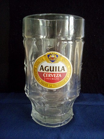 beer glass from the Amstel brewery in Netherlands with the inscription 'Aguila Cerveza 100% Malt Premium Quality Elaborada Segun La Tradicion De Amstel'