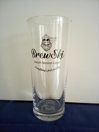 beer glass from the The West Berkshire Brewery brewery in England with the inscription 'Brewski Peach Session Lager Everthing's Peachy'